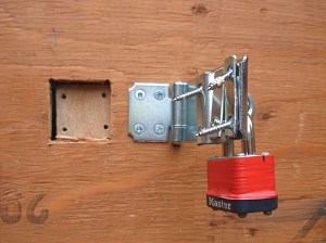 BC Hydro ripped the woodscrews out of the plywood barricade to get past the padlock just one month after BC Energy Minister Bill Bennett said no one would be forced to have a smart meter against their will. (Photo © Kim Goldberg)